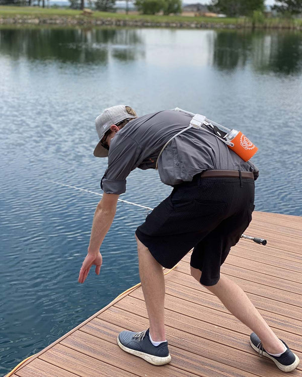 Fishing and bending over - orange Sip-Line tucked behind back