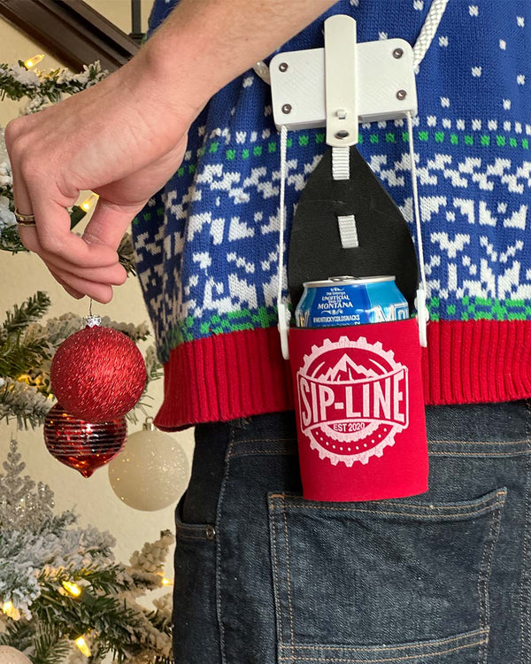 Hanging a Christmas ornament wearing a red Sip-Line